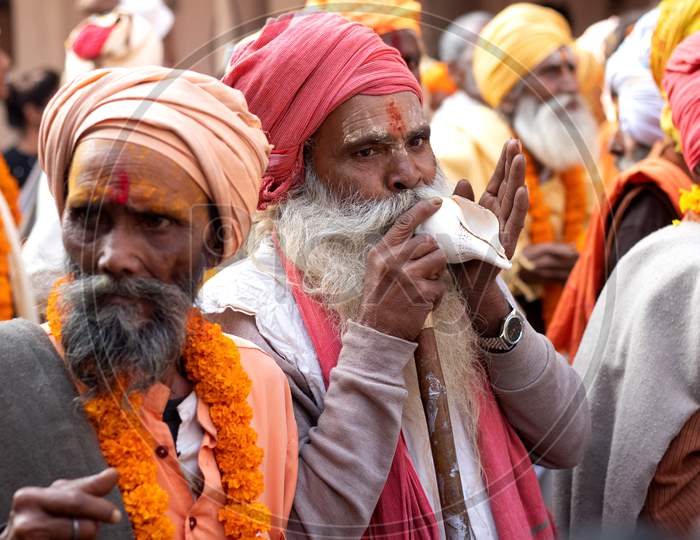 Pushkar,Rajasthan /India. 06 /11/2019. Indian Group Of Old Sadhus With Tilak On Forehead Blowing Sankh In Rally Of Sadhus On Road