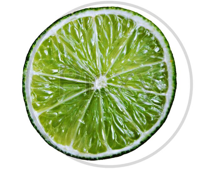 Perfectly retouch green lemon slice isolated on a white background.