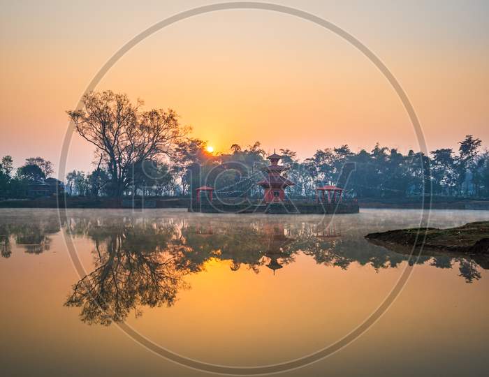 Sunrise behind a temple in the middle of a lake