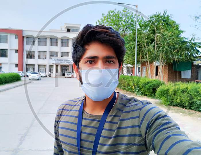 Selfie of Indian boy with mask for anti-virus protection in a public place