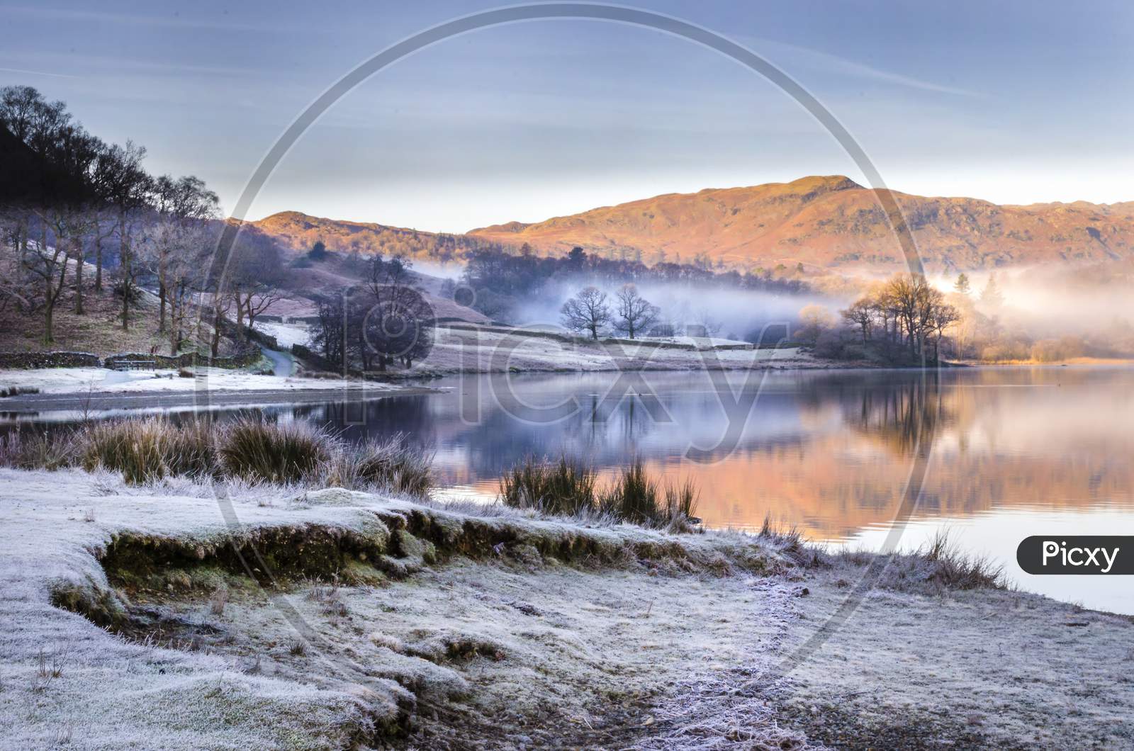 A morning scene of the frost and mist lifting from Grasmere lake