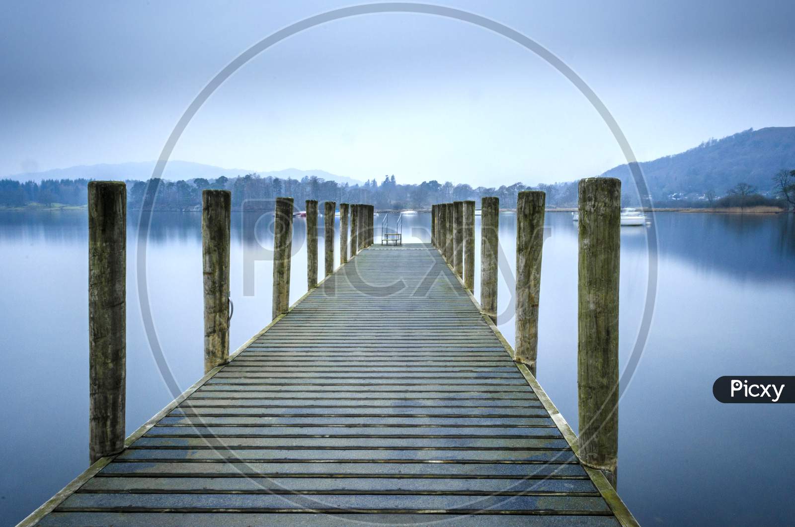 A view of one of the many jetties lining the shore of Lake Windermere in the Lake District UK