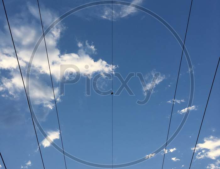 Electric wire with blue sky at background