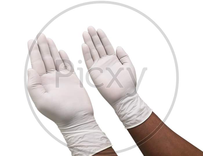 Hands Putting On Protective White Gloves. Latex Gloves As A Symbol Of Protection Against Viruses And Bacteria. Precaution