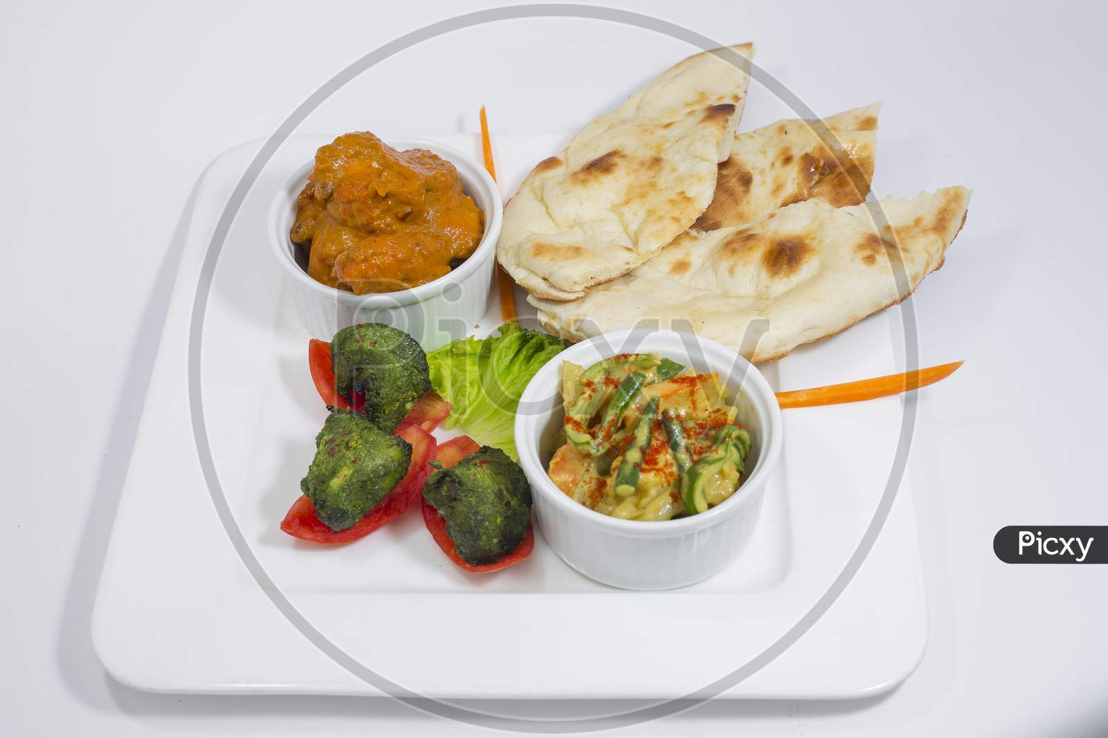 Chicken Harialy Kabab, Chicken Tikka masala curry, Indian Style mix vegetable , plain nan and Green Salad Platter.