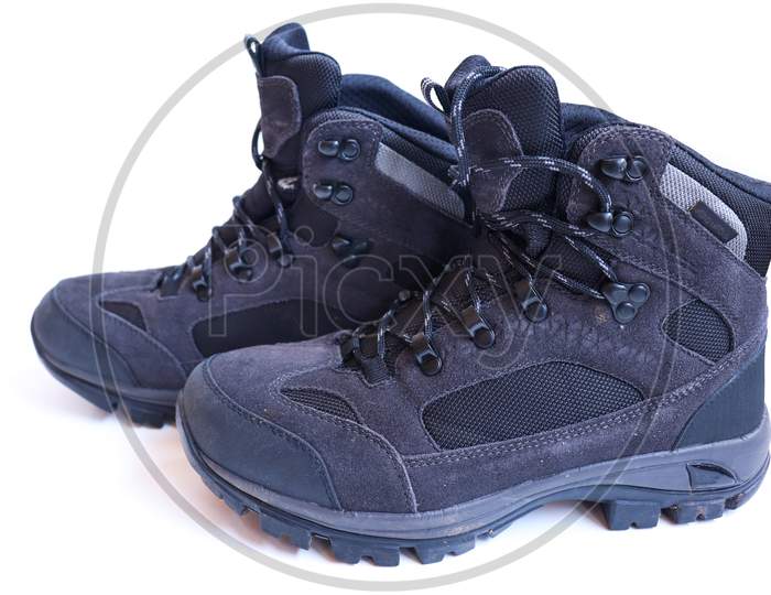 Pair Of Grey Hiking Boots On A White Background.
