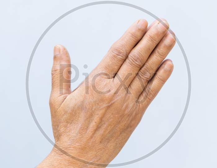 Senior Woman Hand Folded Against Plain Background