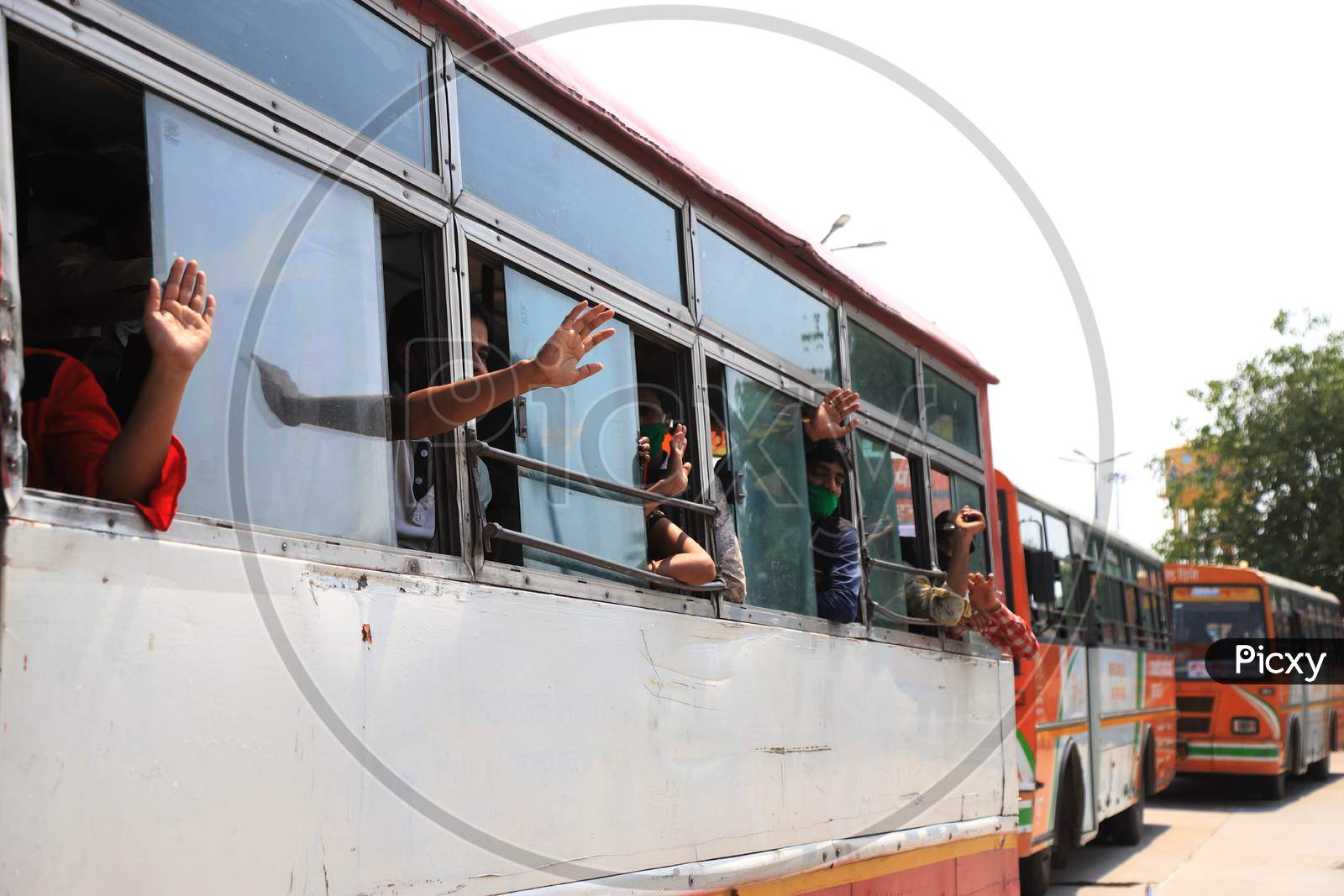  Migrant Workers Wave After Boarding Buses Towards their hometowns During Nationwide Lockdown Amidst Coronavirus Or COVID- 19 Pandemic, in Prayagraj, May 10 , 2020
