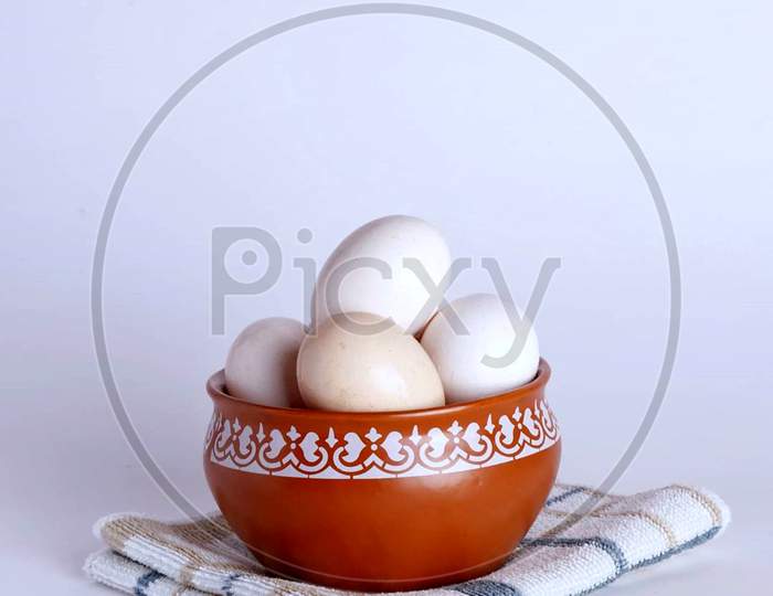 Boiled eggs in bowl in white background