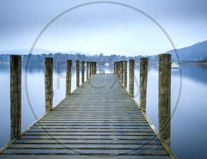 A view of one of the many jetties lining the shore of Lake Windermere in the Lake District UK