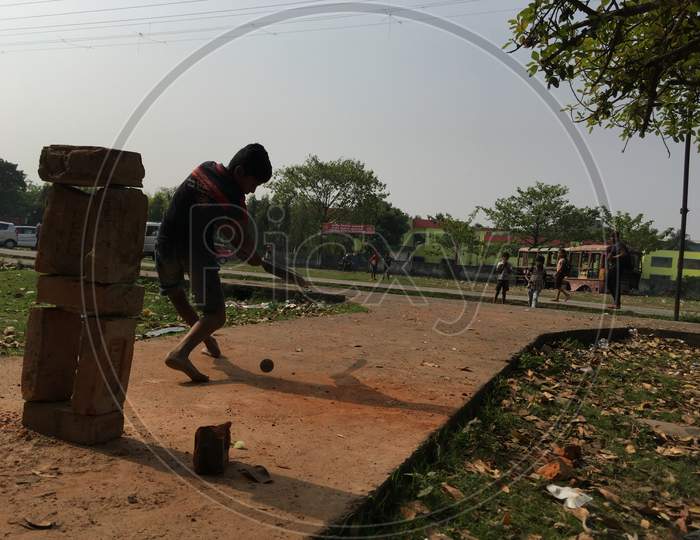 Street boys playing cricket at outdoors