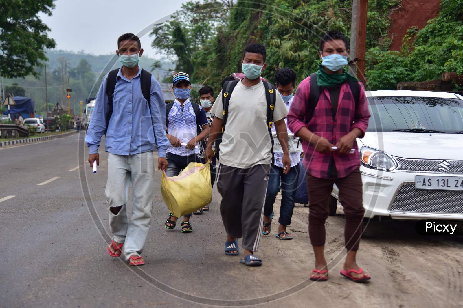 Migrant Workers  Walk Along A Road To Return To Their Villages During Nationwide Lockdown Amidst Coronavirus or COVID-19 Pandemic On The Border Of Assam  And  Meghalaya  In Guwahati,India