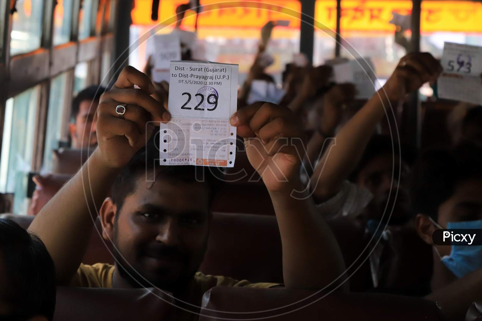 Migrant Workers From Gujarat  Showing Train Ticket After Boarding Buses During Nationwide Lockdown Amidst Coronavirus Or COVID- 19 Pandemic, in Prayagraj, May 6, 2020