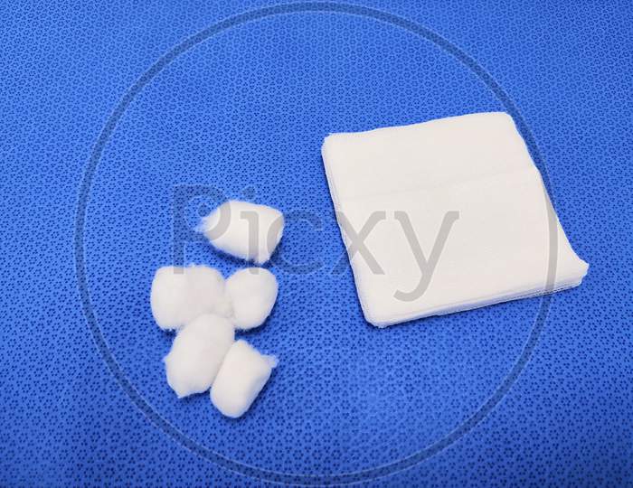 White Medical Gauze And Cotton Swab In Blue Background