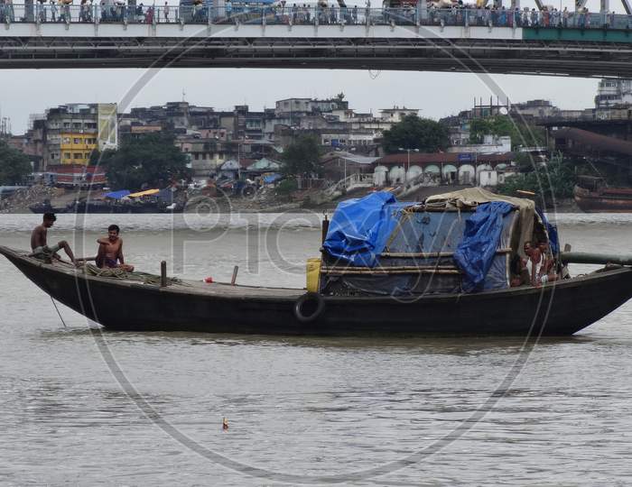 Fishing boat in ganga river at kolkata background wallpaper