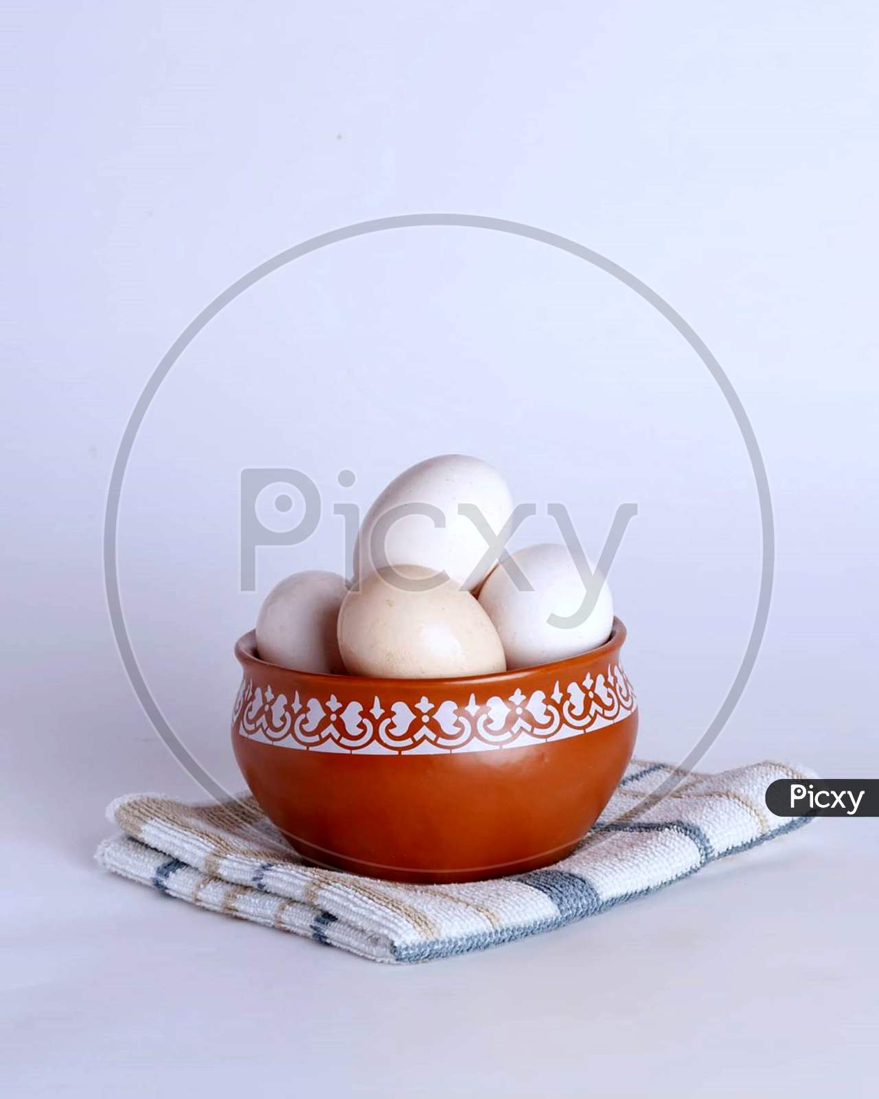 Boiled eggs in bowl in white background