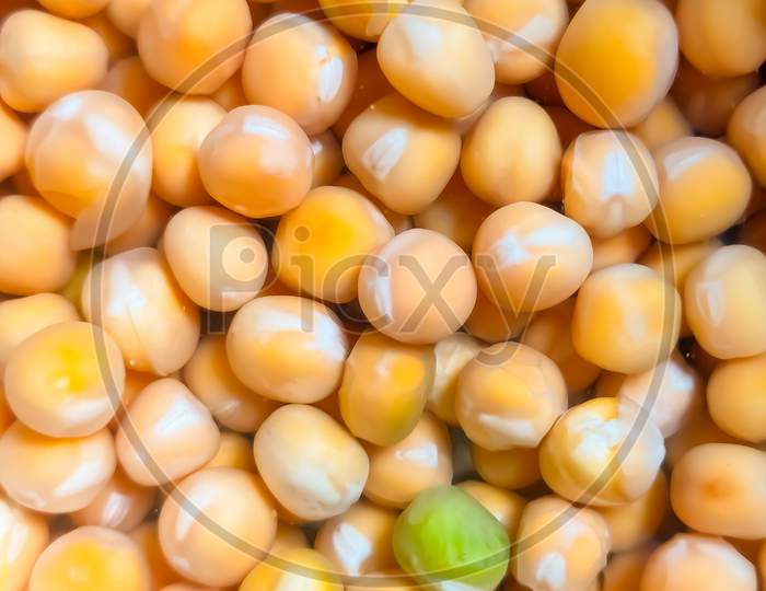 A concept closeup picture of yellow grains soaked in water