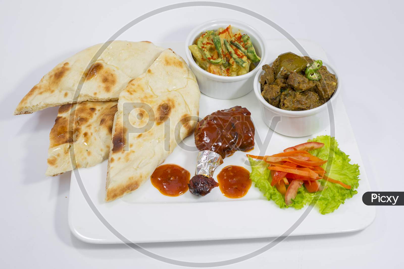 Achary Beef Curry, BBQ Chicken, Indian Style mix vegetable, plain nan and Green Salad Platter.