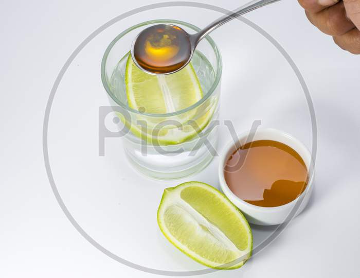 Glass of warm water with lemon and honey.