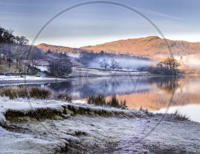 A morning scene of the frost and mist lifting from Grasmere lake