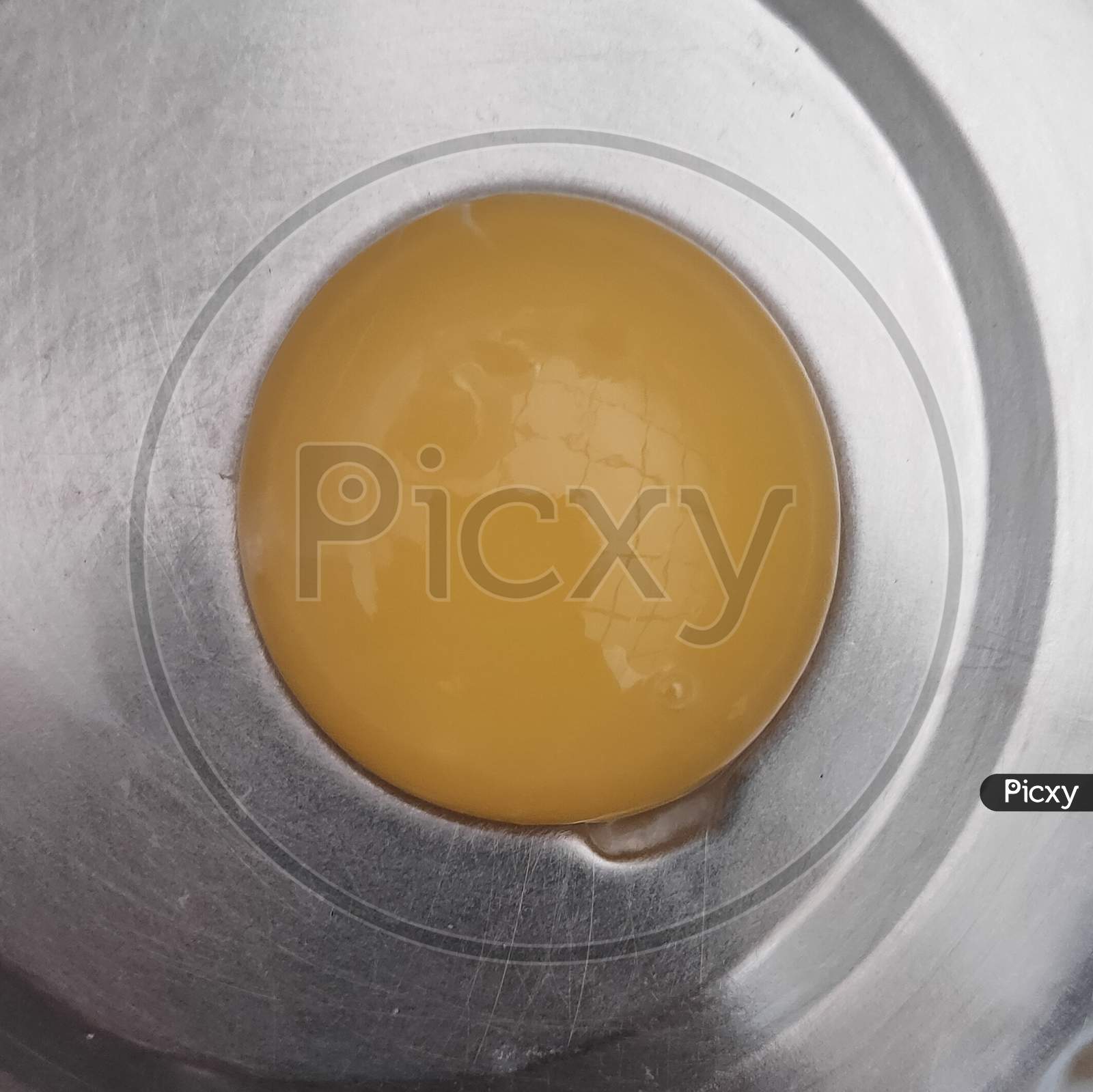 Egg yolk close up in steel vessel