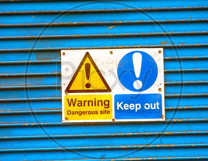 Warning notice on metal shutter doors.