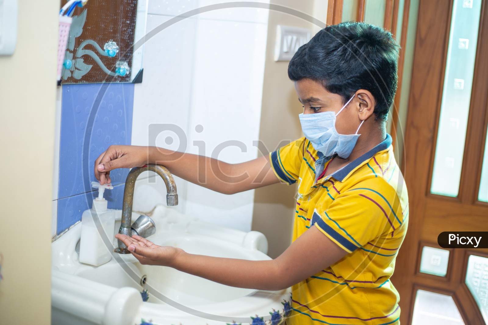 Kid Wearing Mask Washing Hands With Alcohol Gel Or Antibacterial Soap Sanitizer, Hygiene Concept. Prevent The Spread Of Germs And Bacteria And Avoid Infections Corona Virus.