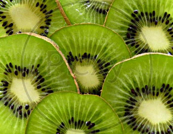 Retouching kiwi slice.healthy and nutritious food.sliced kiwi fruit background.