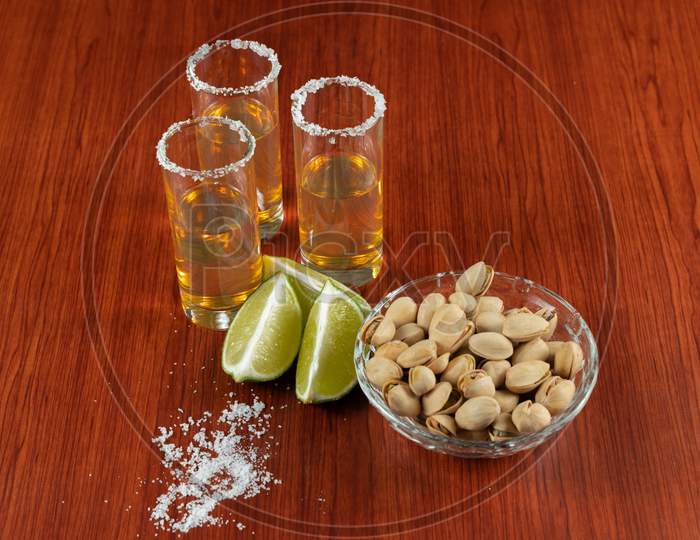 Golden Tequila With Lemon, Pistachos, Cacahuate, And Salt. Drinks, Liquor