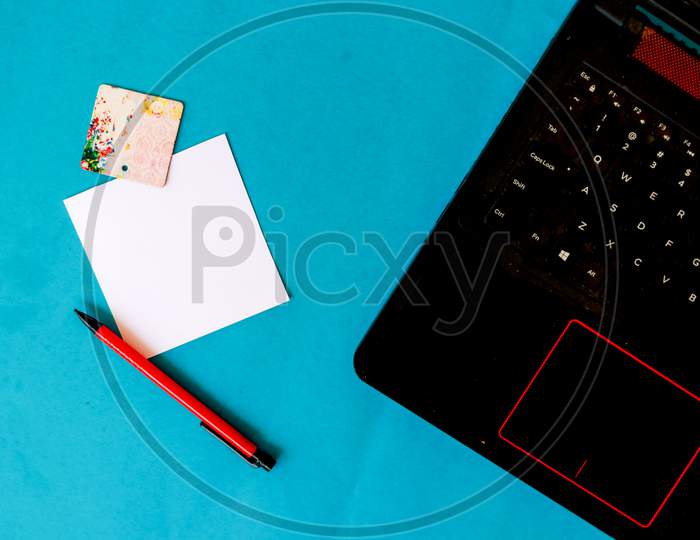 "Pastel Office Desk Table With Laptop Computer And Supplies. Top View With Copy Space, Flat Lay."Beauty Office Desk With Laptop, Notebook And Pen On Blue Background