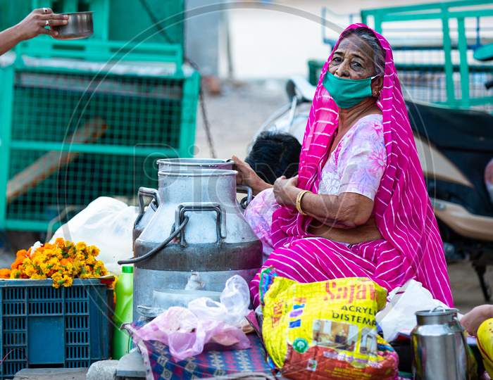Jodhpur, Rajashtbn, India. 30 March 2020. Old Woman Wearing Protective Mask Selling Food On Road Due To Lock Down, Coronavirus, Covid-19 Outbreak In India.