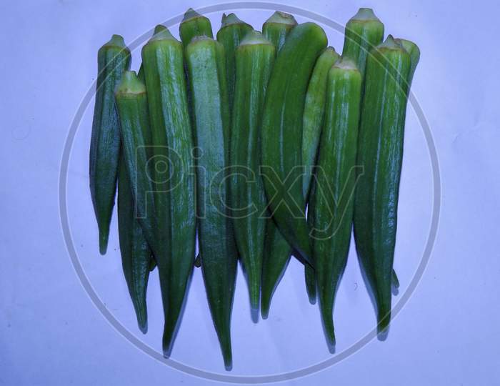 bunch of fresh green lady finger in white background