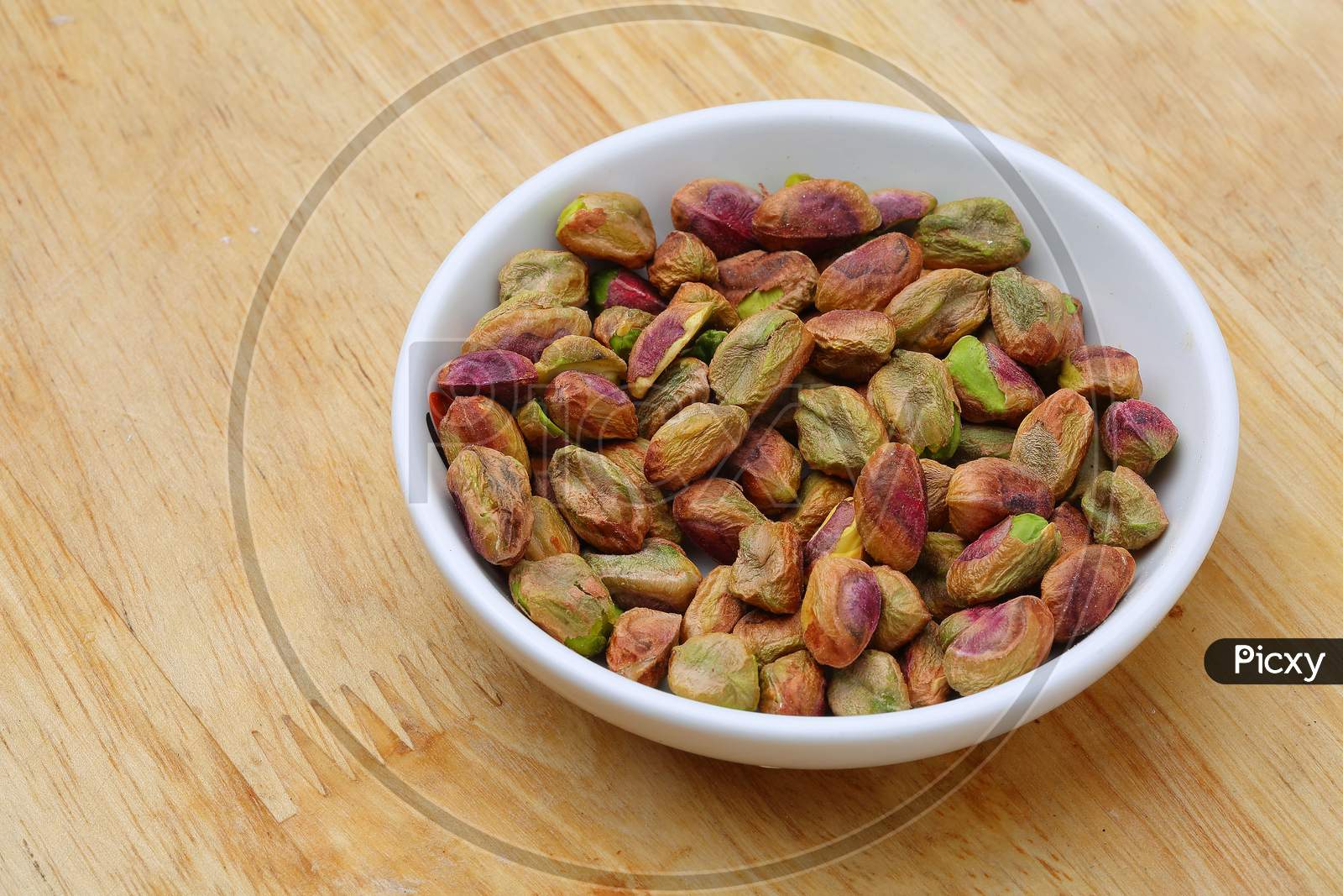 Pistachio Nuts on wood Background