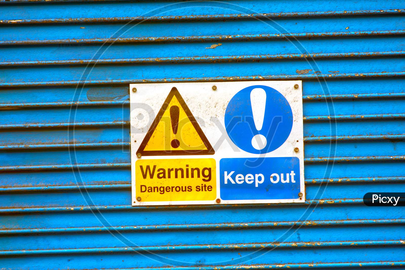 Warning notice on metal shutter doors.