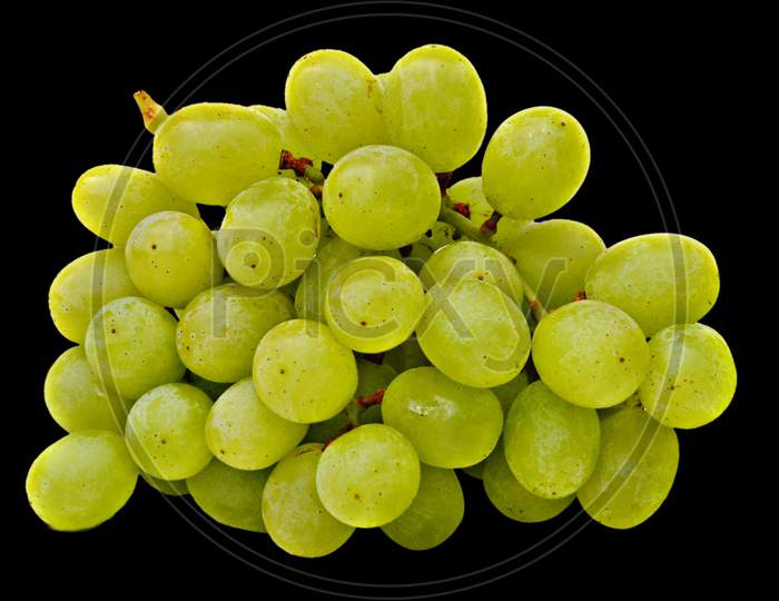 A branch of grapes isolated on black background.healthy diet, nutritious food.