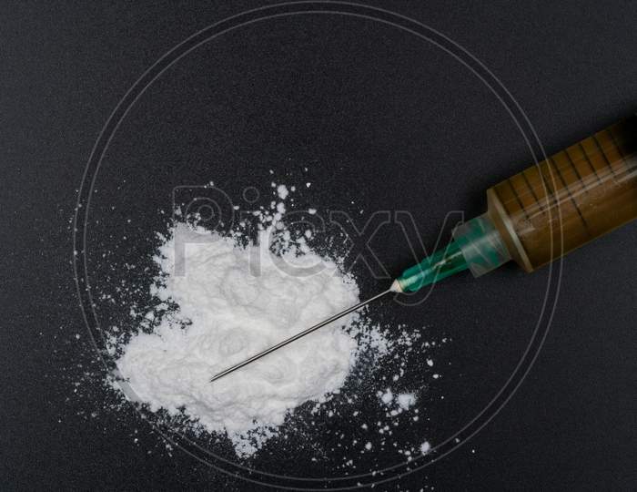 Cocaine Or Other Illegal Drugs, White Powder, Syringe, Isolated On Black Glossy Background