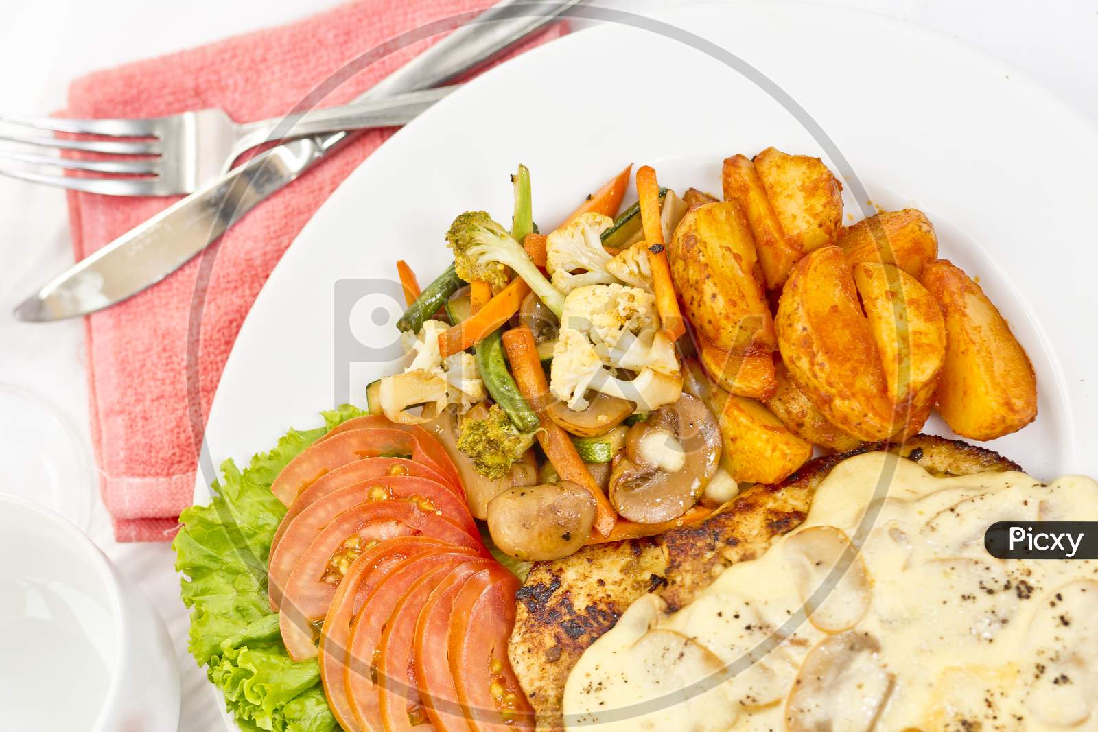 Peri Peri Chicken With Button Mushroom Gravy, Saute Vegetables, Spicy Fried Potatoes With Tomato Lettuce Salad.