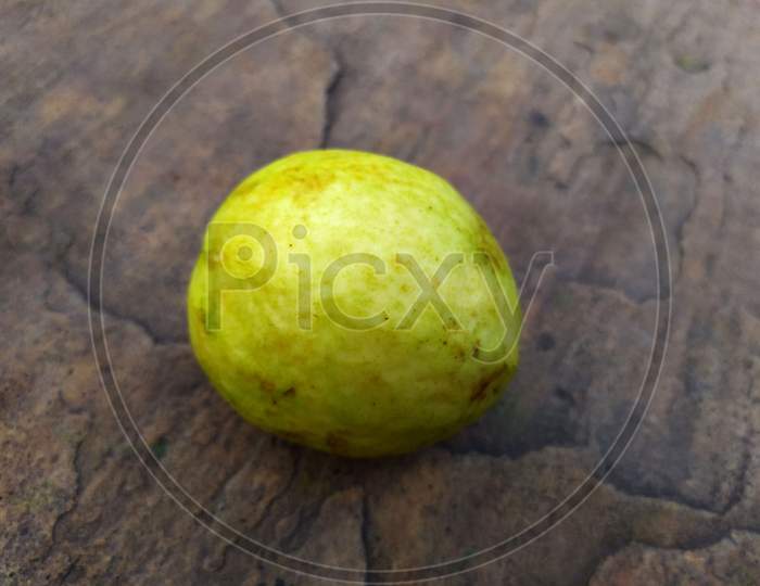 FRESH SWEETS GREEN GUAVA ISOLATED ON A STONE BACKGROUND