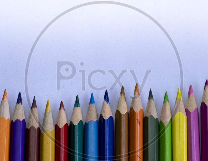 Group Of Colorful Wooden Pencils On Grainy White Background And Space For Text On Above