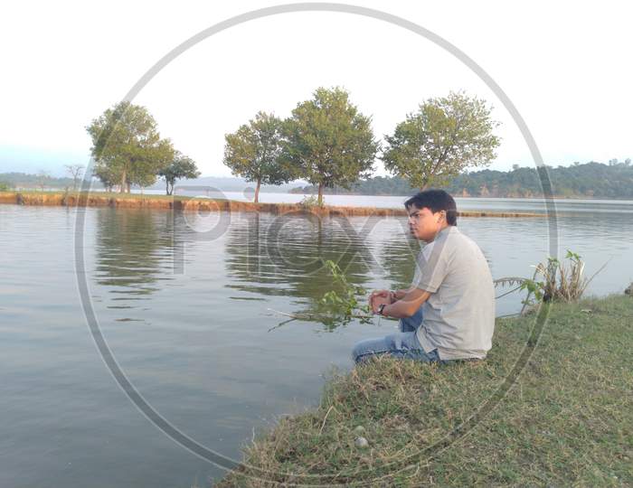 Indian man sitting inside of water beautiful tourist place river and mountain