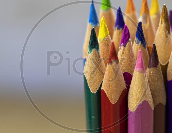 Group Of Colorful Wooden Pencils Close-Up Shot With Selective Focus Or Shallow Depth Of Field And Space For Text On Left Side