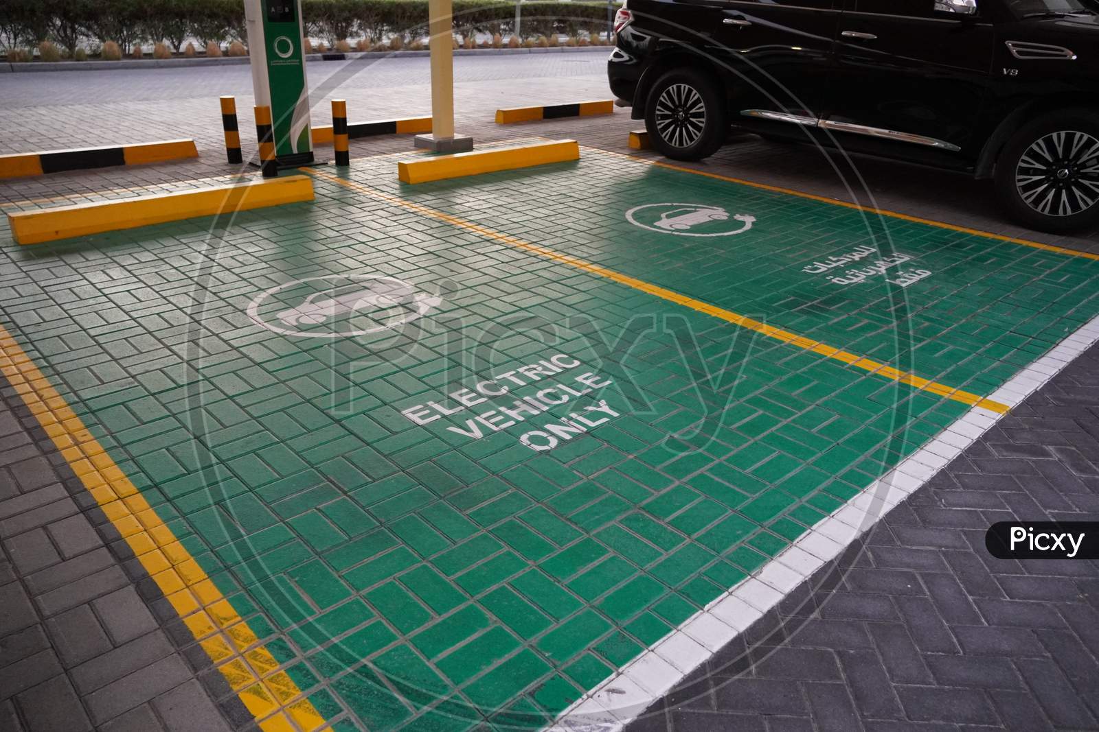Green Electric Vehicle Charging Station Sign In A Parking Bay. Electric Vehicle Parking Space. Electric Car Charging Station. Dubai Uae December 2019