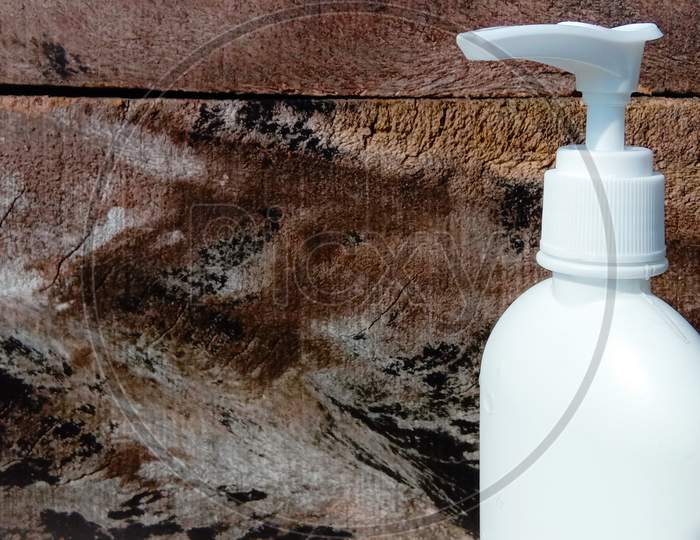 Hand sanitizer bottle with white wooden background.Corona virus germ cleaning hand wash plastic bottle.Hygiene.