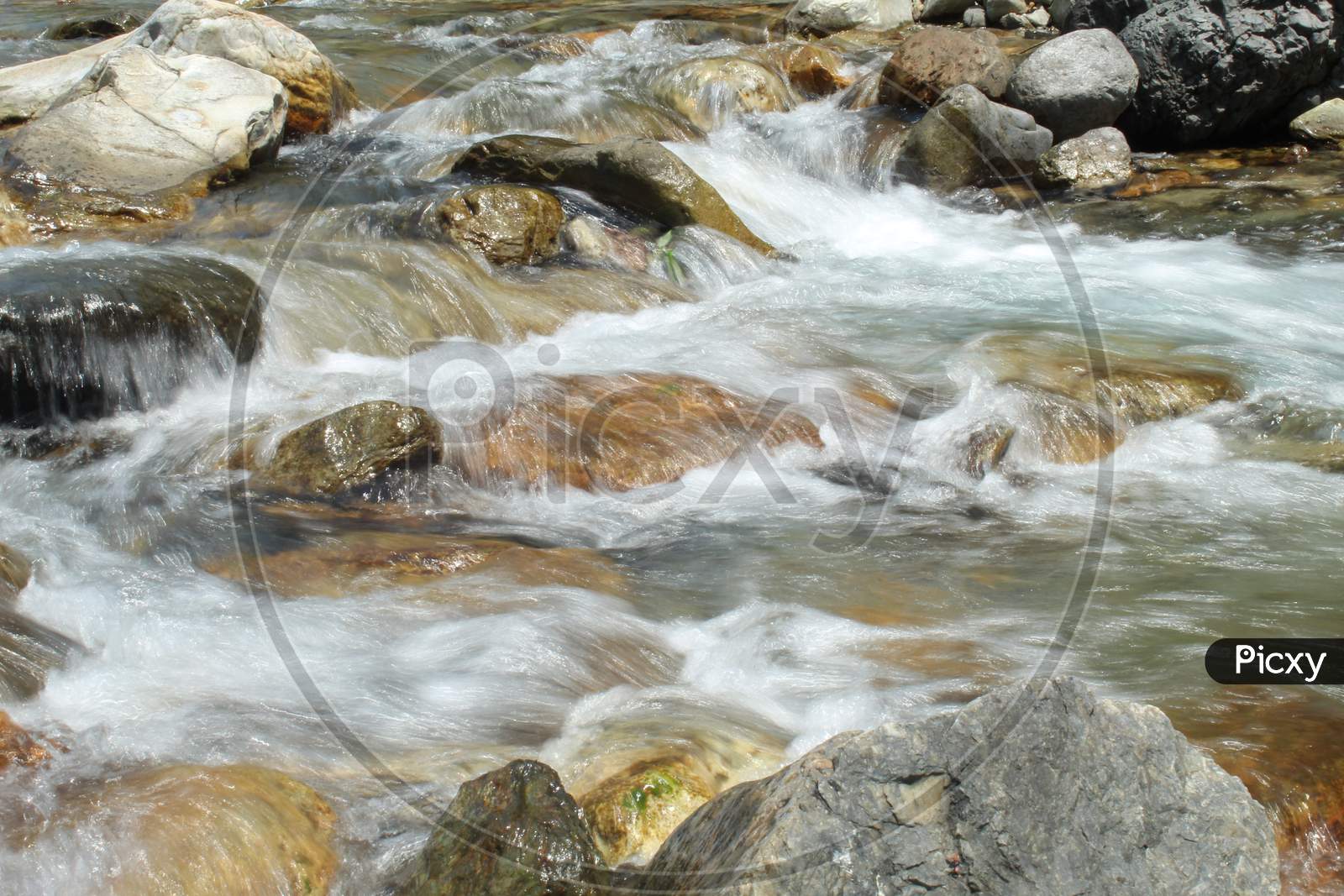 River Water Flowing On Stone Banks