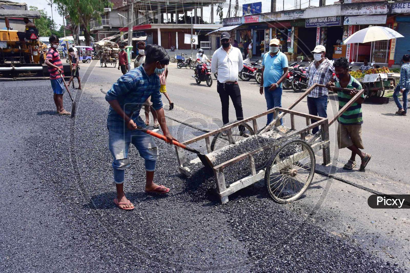 Labourers Work On A Road Construction After Authorities Eased Restrictions, During Nationwide Lockdown Amidst Coronavirus Or COVID-19 Pandemic In Nagaon District Of Assam On May 7,2020