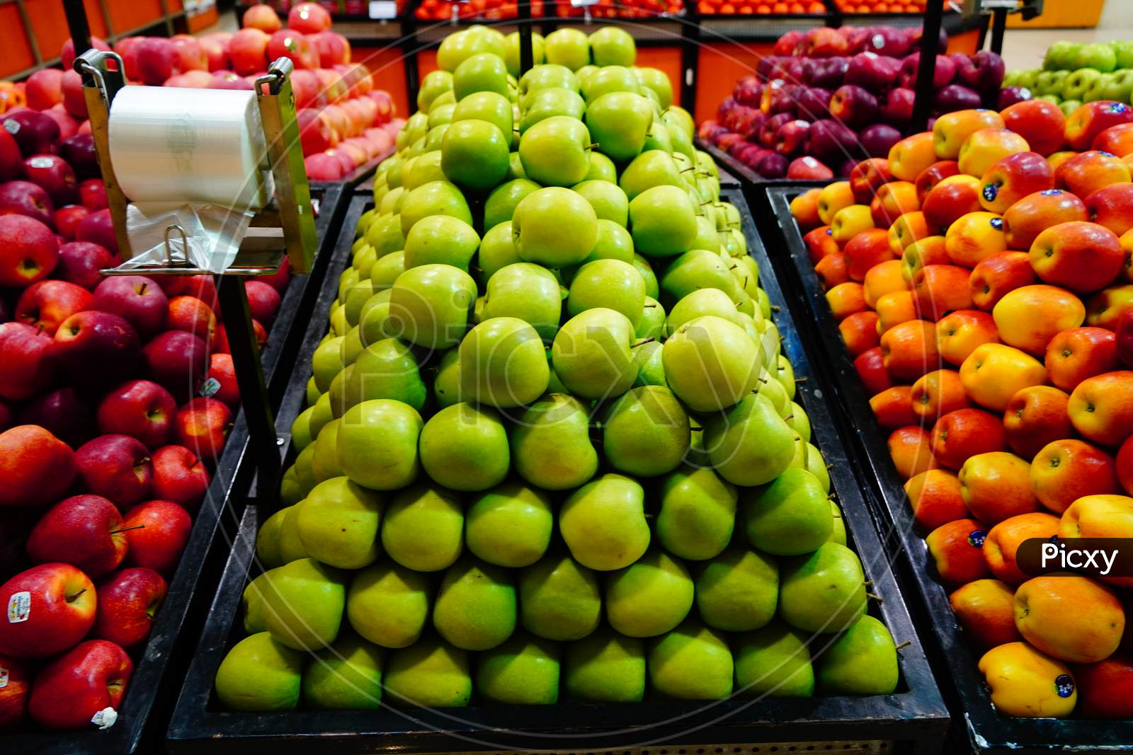 Bunch Of Green, Orange, Red Apples On Boxes In Supermarket. Apples Being Sold At Public Market. Organic Food Fresh Apples In Shop, Store - India