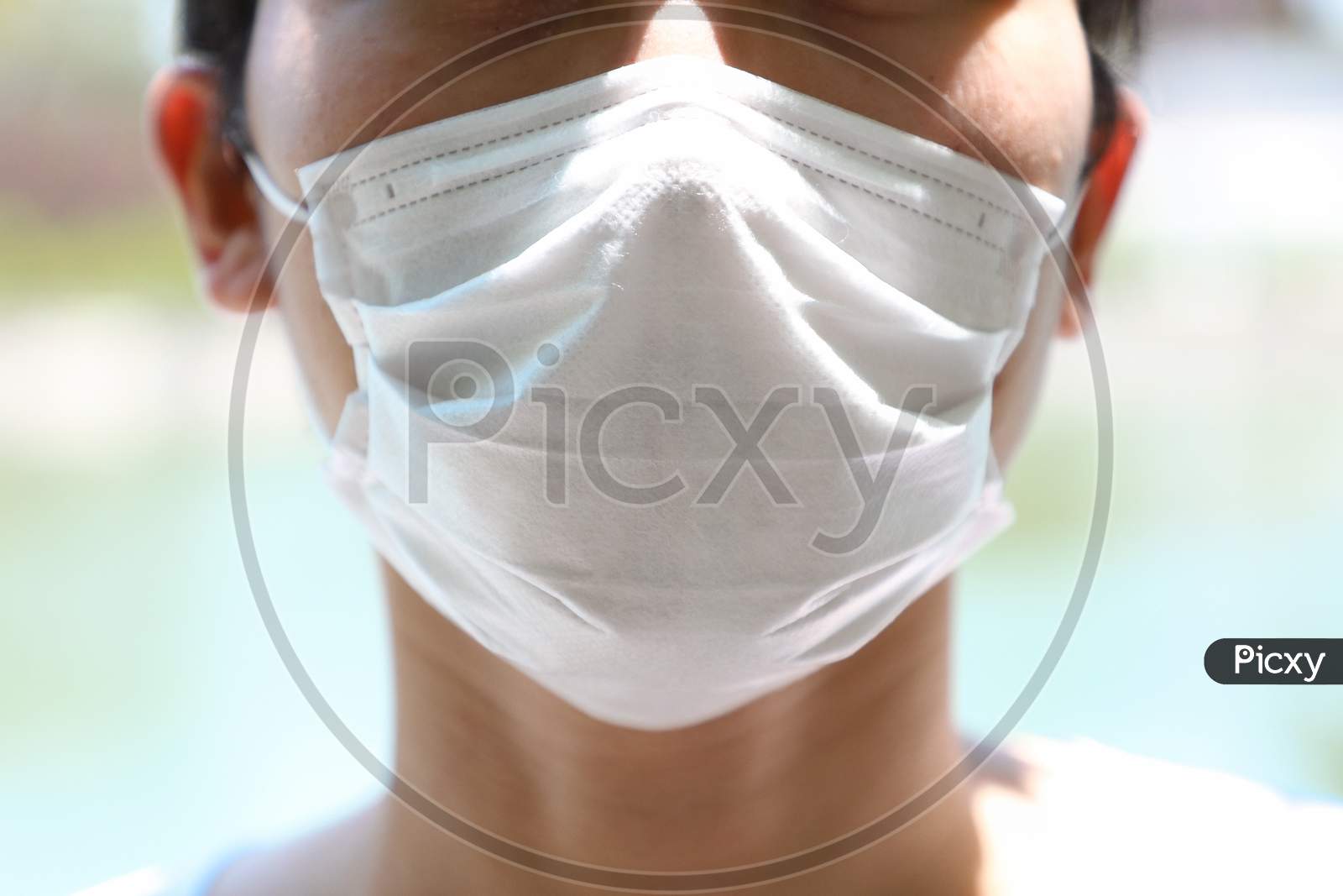 Man wearing hygienic mask to prevent infection.
