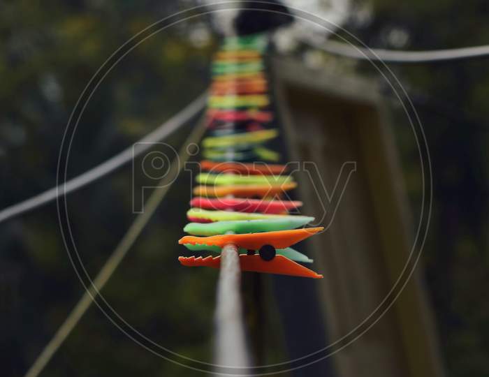 Some plastic clips are on the rope with blurred background.