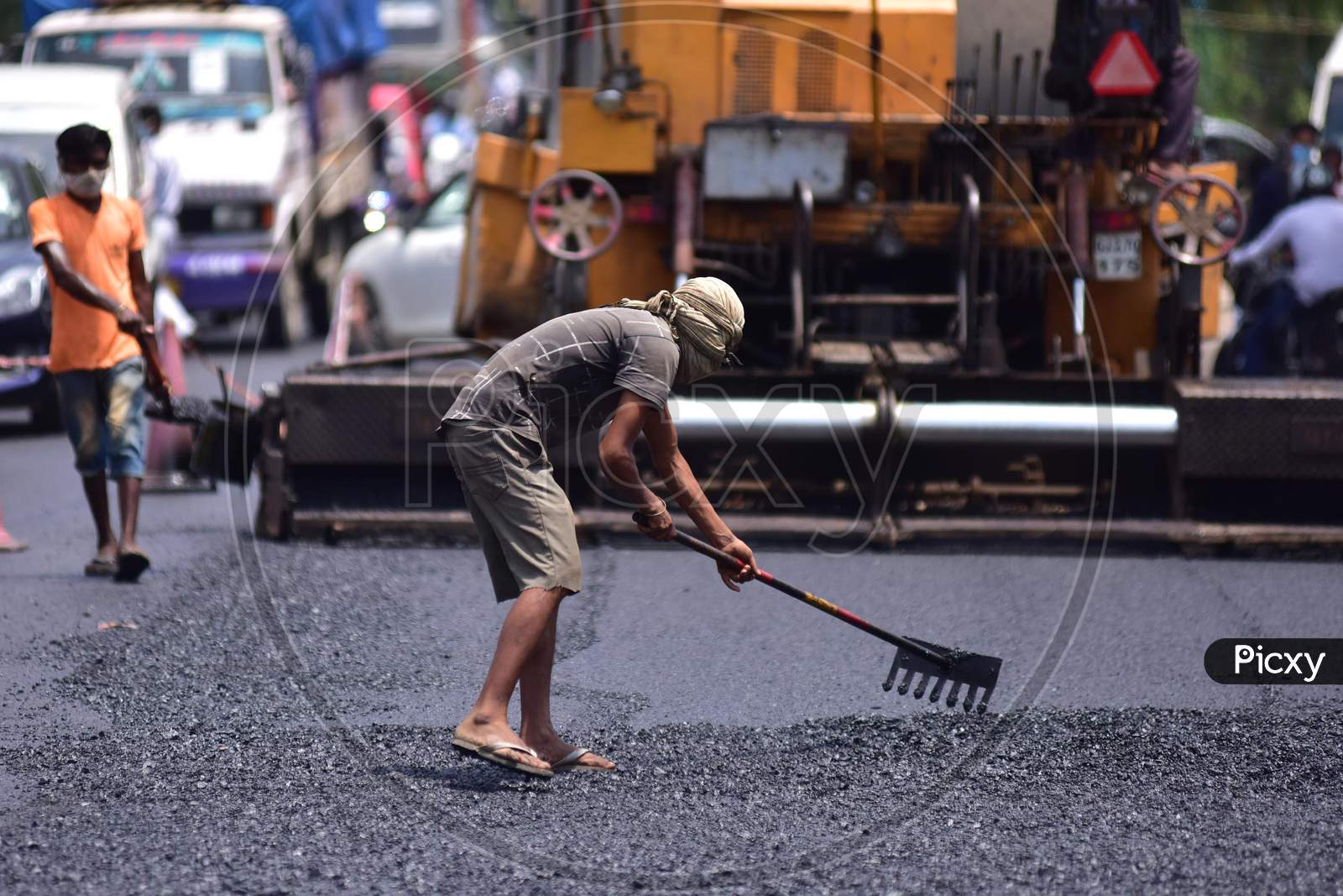 Labourers Work On A Road Construction After Authorities Eased Restrictions, During Nationwide Lockdown Amidst Coronavirus Or COVID-19 Pandemic In Nagaon District Of Assam On May 7,2020