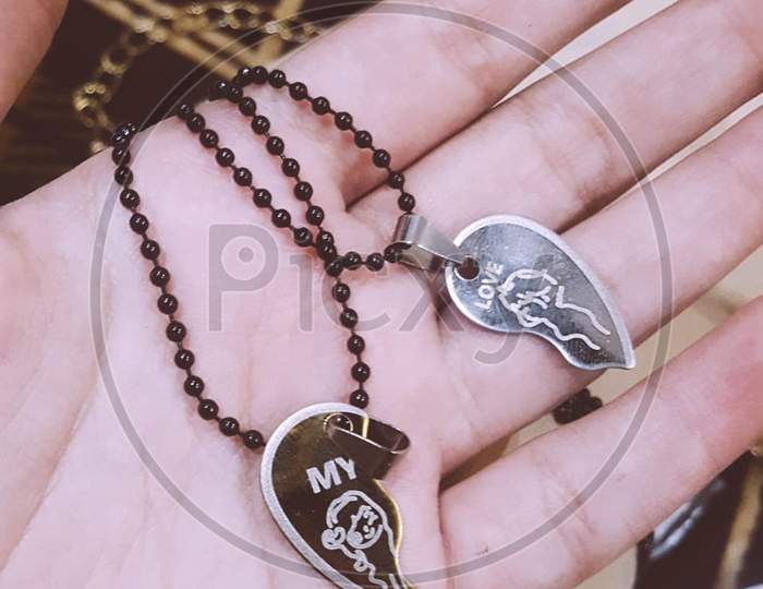 My Love two necklaces of heart with black chain in someone's hand